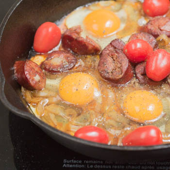 Tomatoes and eggs added to the pan. 