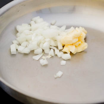 Onion and margarine in a pan.