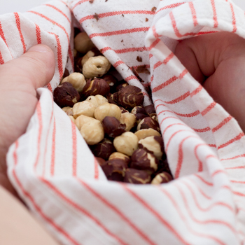 rubbing hazelnuts with kitchen towel