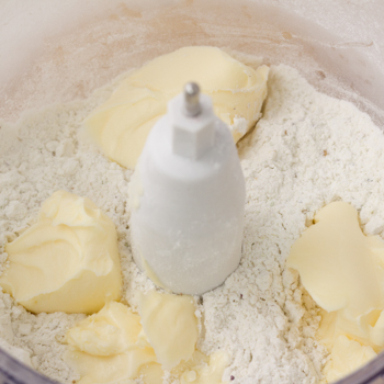 Margarine mixed into the mixture of the food processor in clumps.