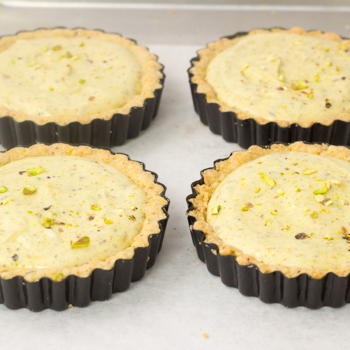 Fill the tarts with pistachio mousse filling.