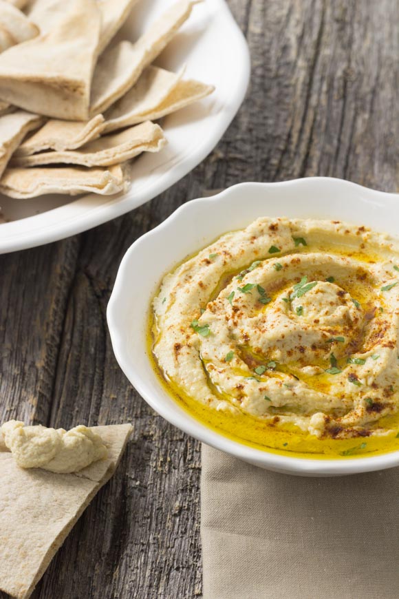 hummus in a bowl with pita