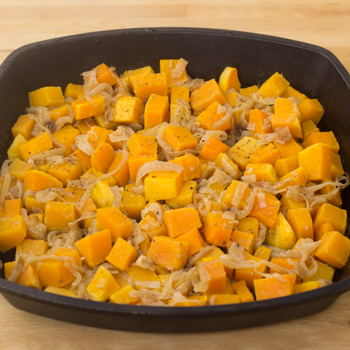 Squash added to cast iron pan with onions.